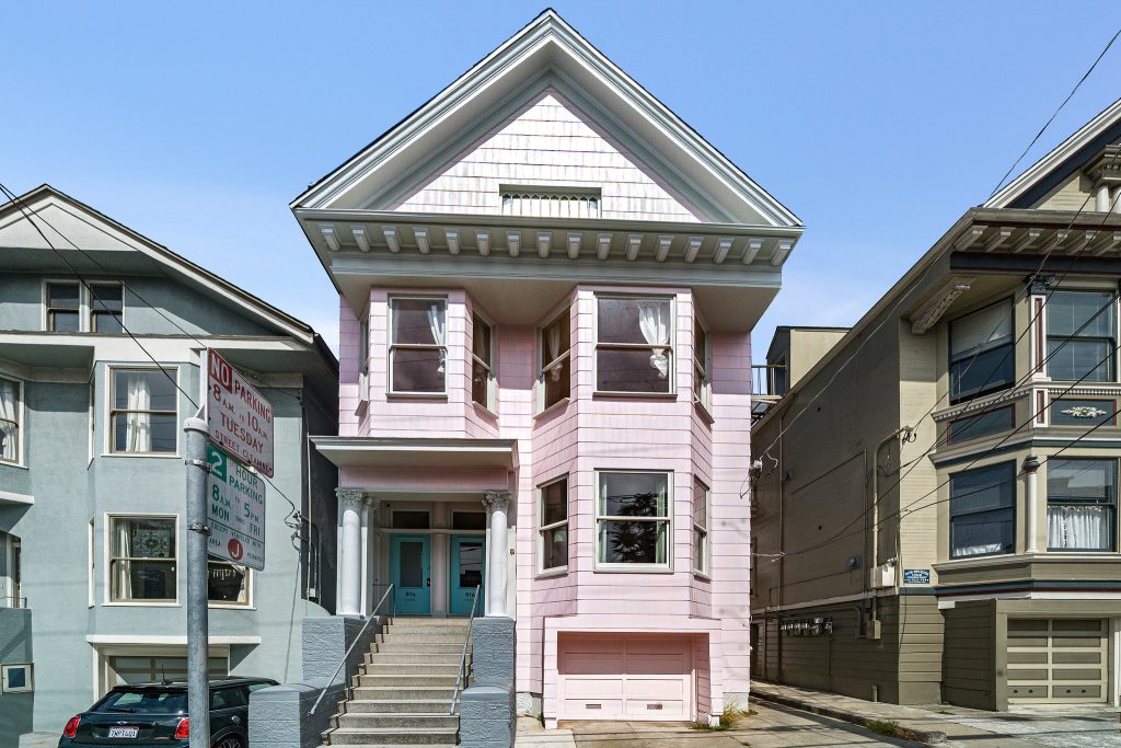 Exterior view of 814-816 Cole Street, featuring a pink facade