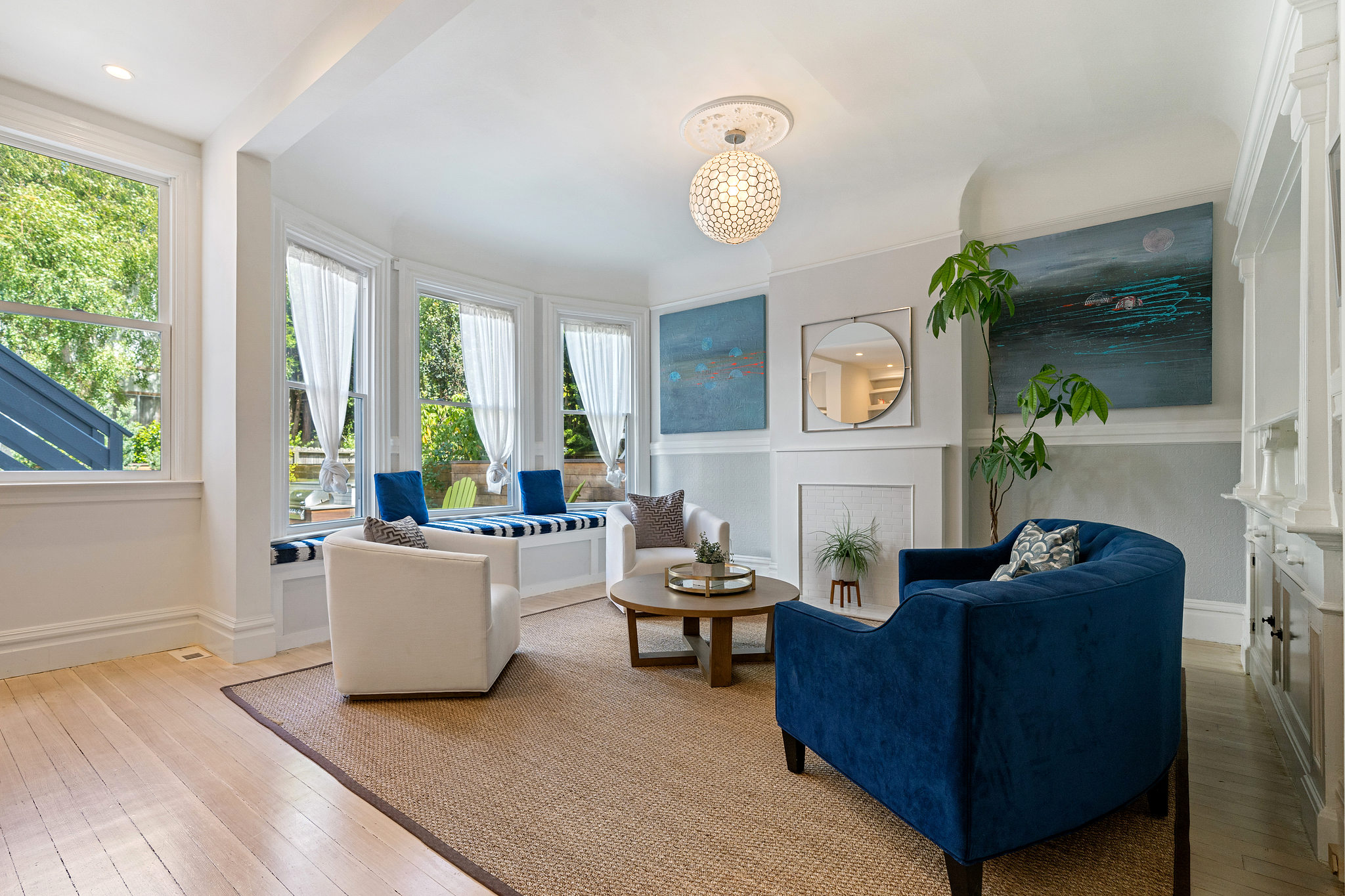 Living room with four large windows and a mantle