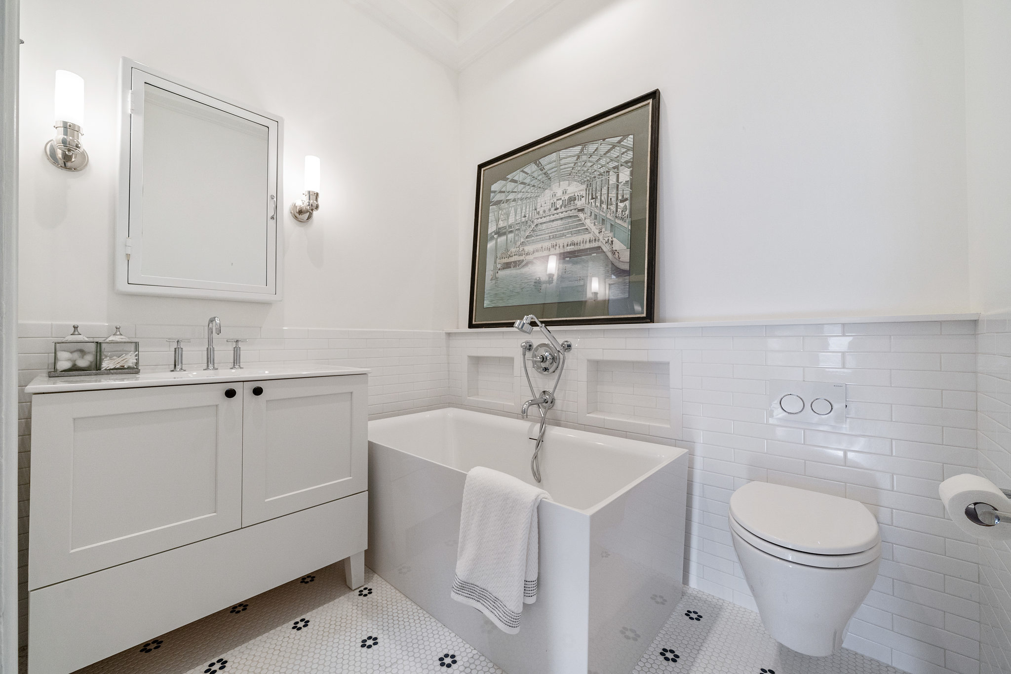 Bathroom with large tub and white cabinet