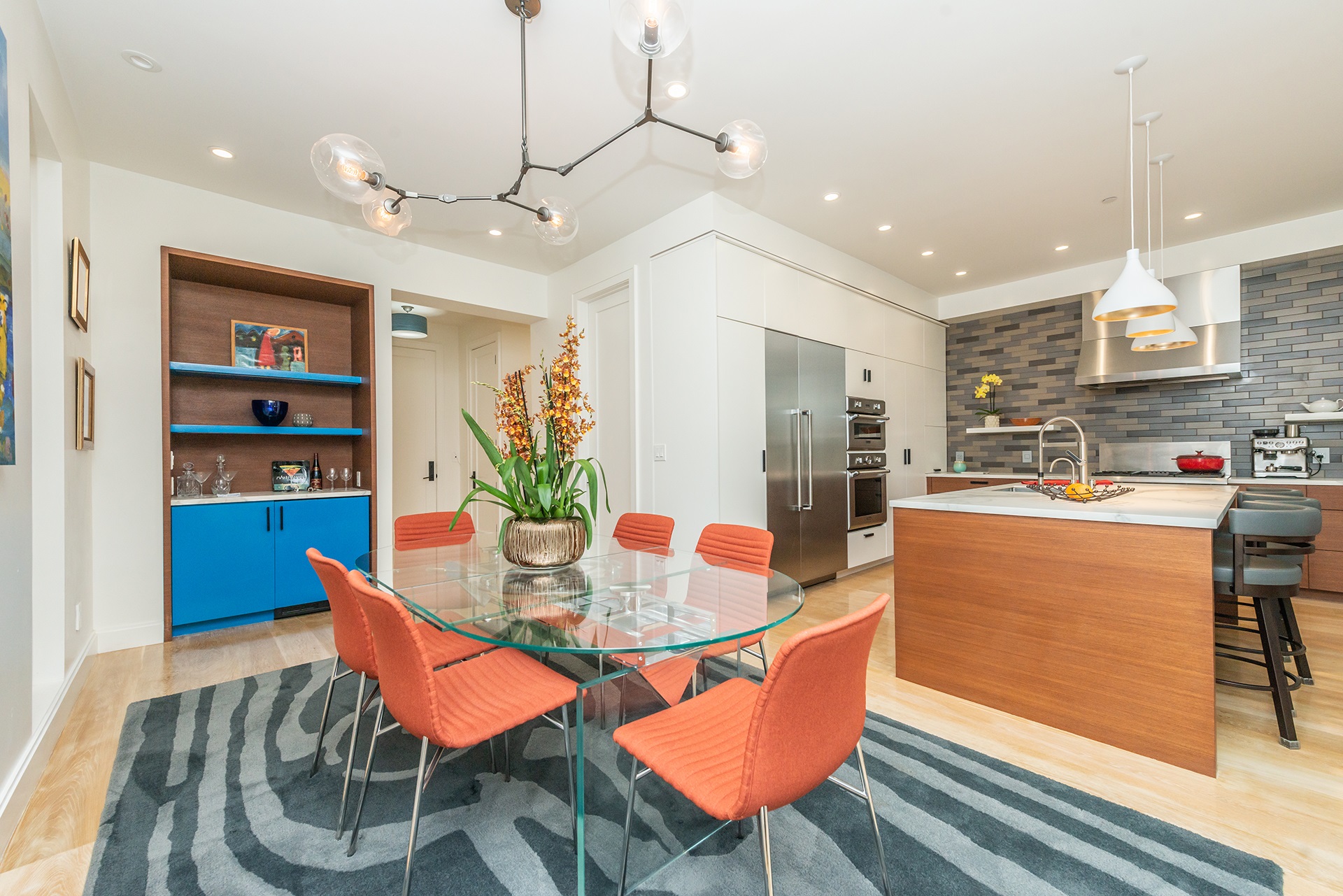 Dining table fits 6 and there is a built in cabinets with blue doors.