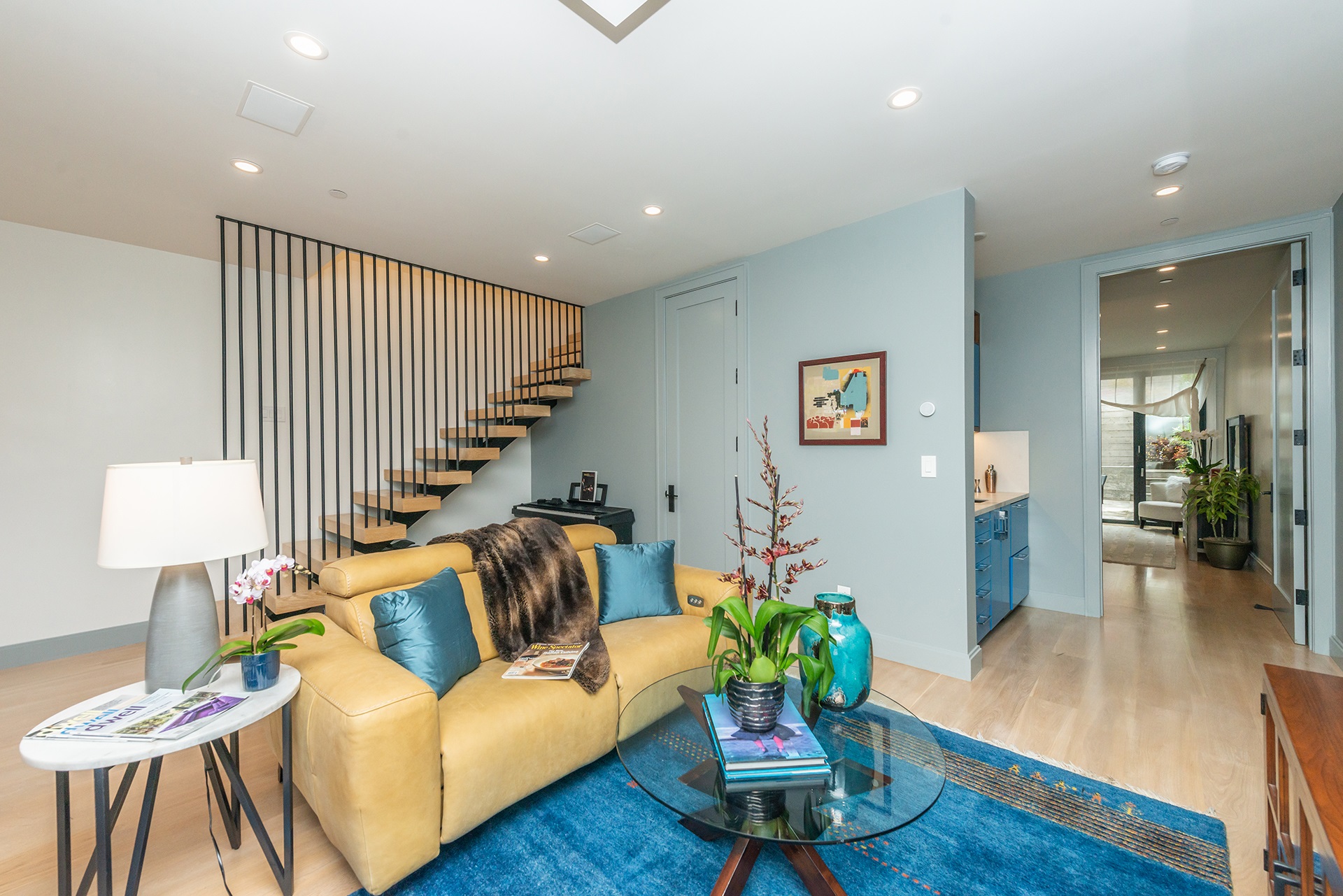 Living space on the lower lever. Nice leather couch in the center of the room.