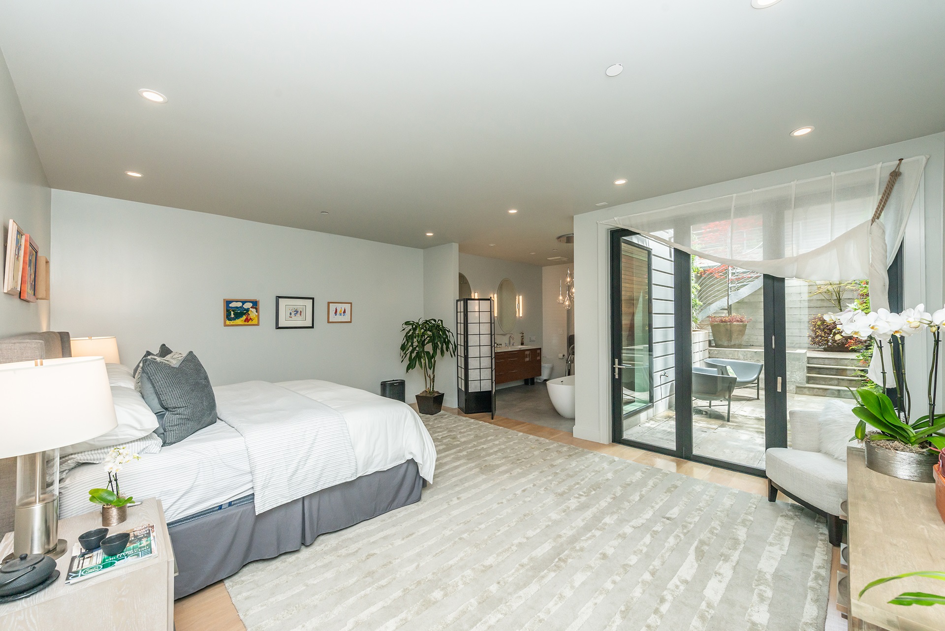 Primary suite. There is large floor to ceiling doors that open up to lower patio.