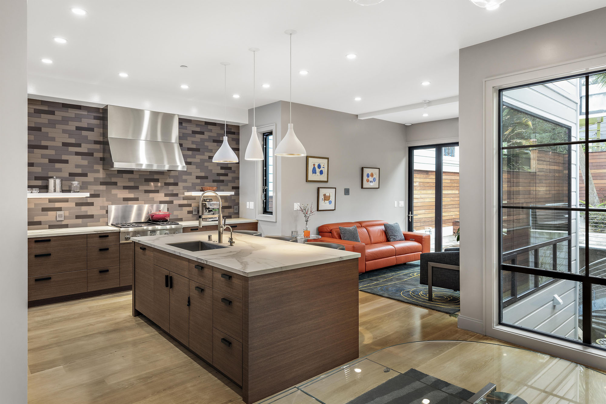 There are large windows in living space and behind dining table. All open floor plan.
