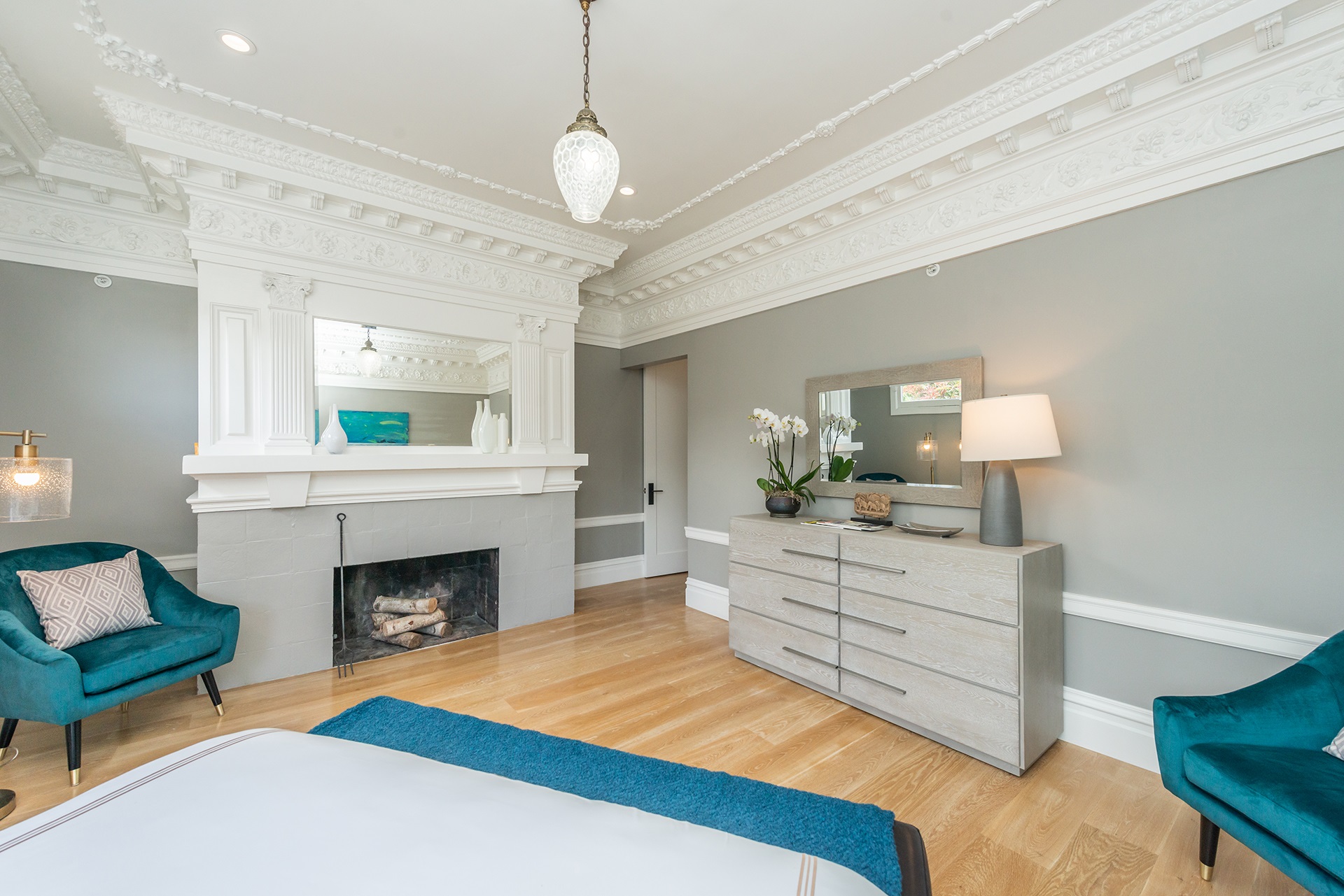 There is a fireplace with a large mantel that has built in mirror.
