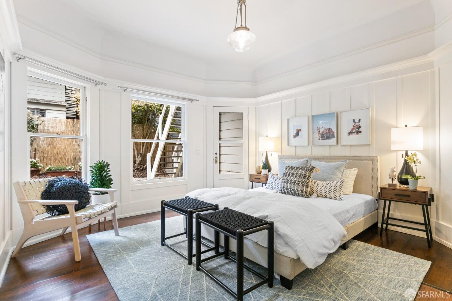 2nd bedroom has woodfloors and lots of molding detail. There is a door that opens out to back yard.
