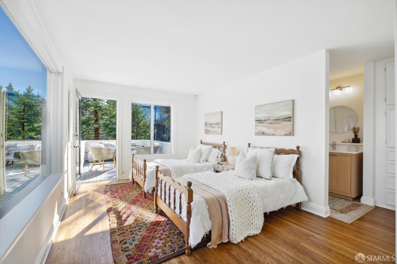 Guest room with 2 double beds.  Also has french doors that open up to outdoor patio.