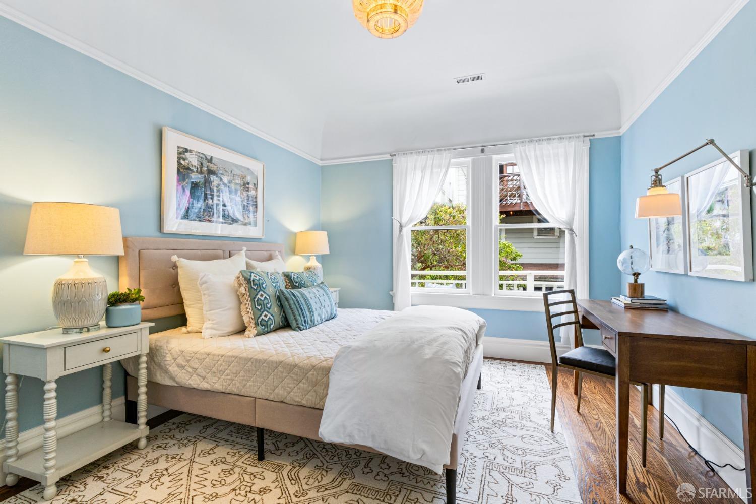 Guest bedroom has bed and small desk.