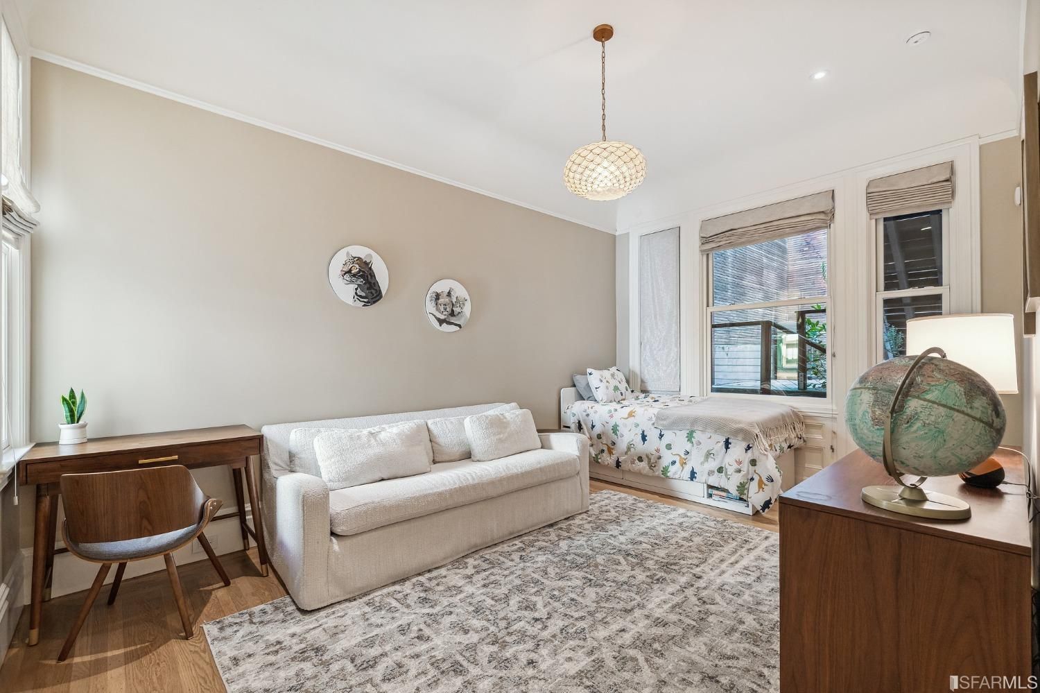 Bedroom four, featuring wood floors and windows on opposing walls plus modern light fixture