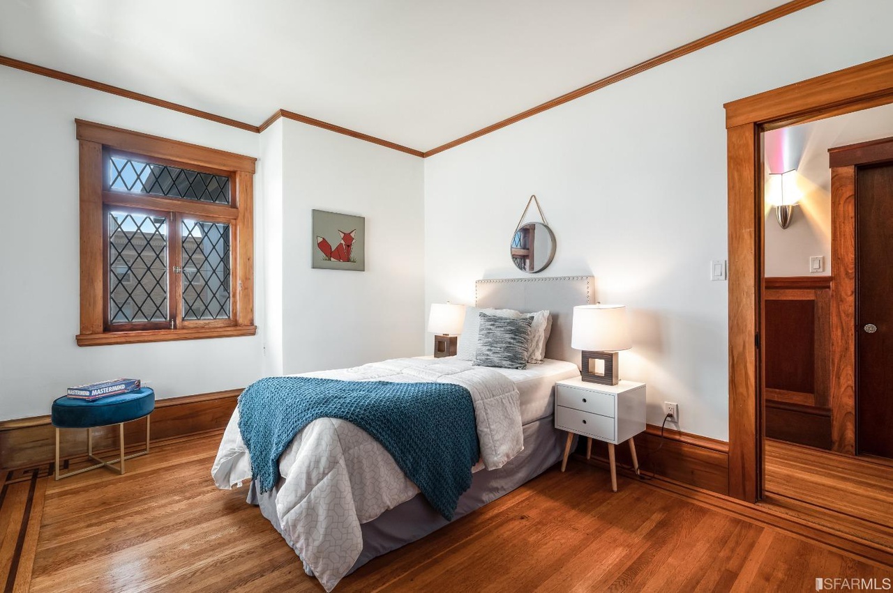 Bedroom5 Bedroom three, featuring wood floors and plenty of natural light