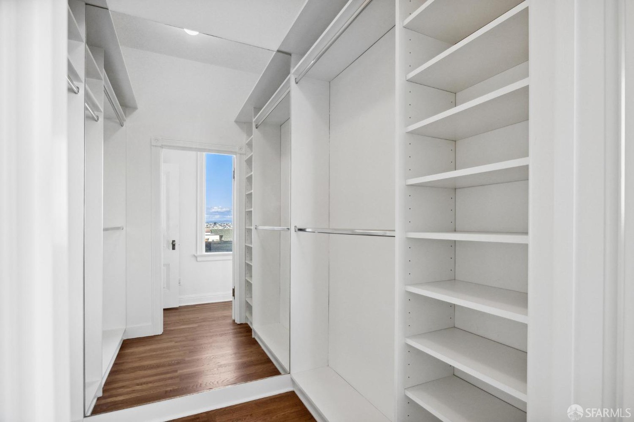 Large walk in closet. There is mirror on back wall that makes closet look large.