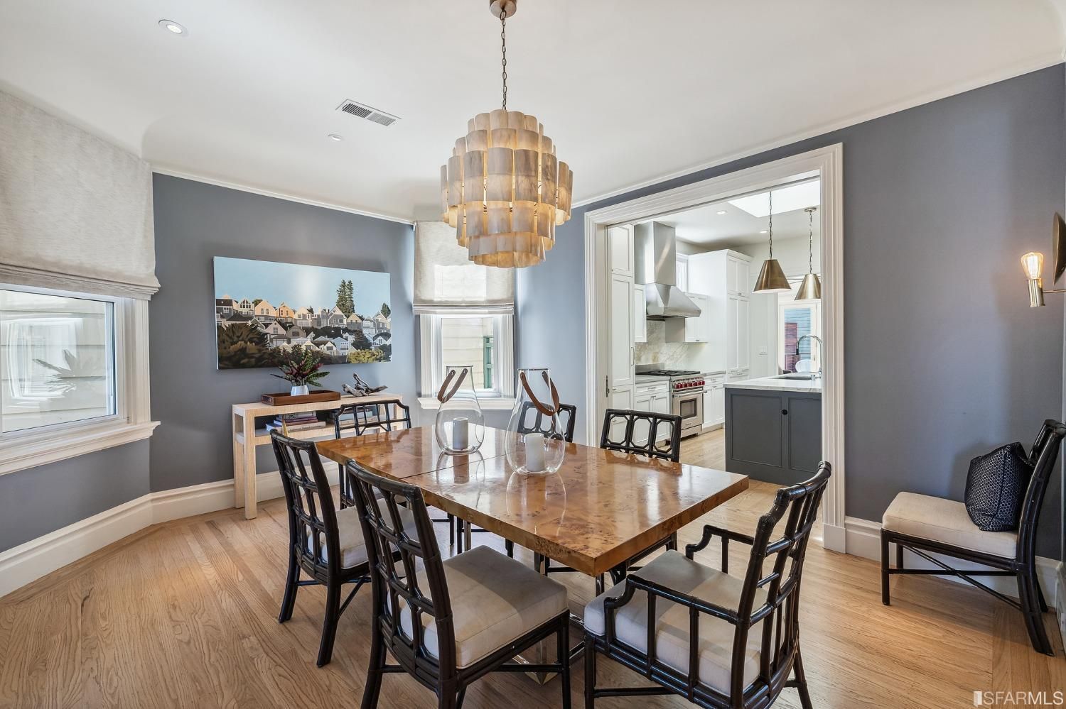 Formal dining room showing a large chandelier and wood floors