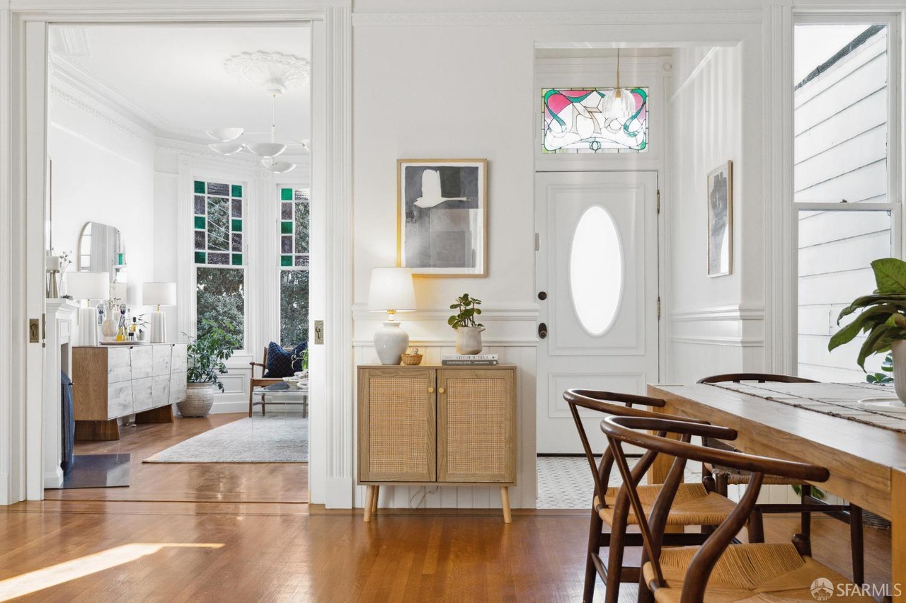 Main entry door has beautiful stained glass window above.