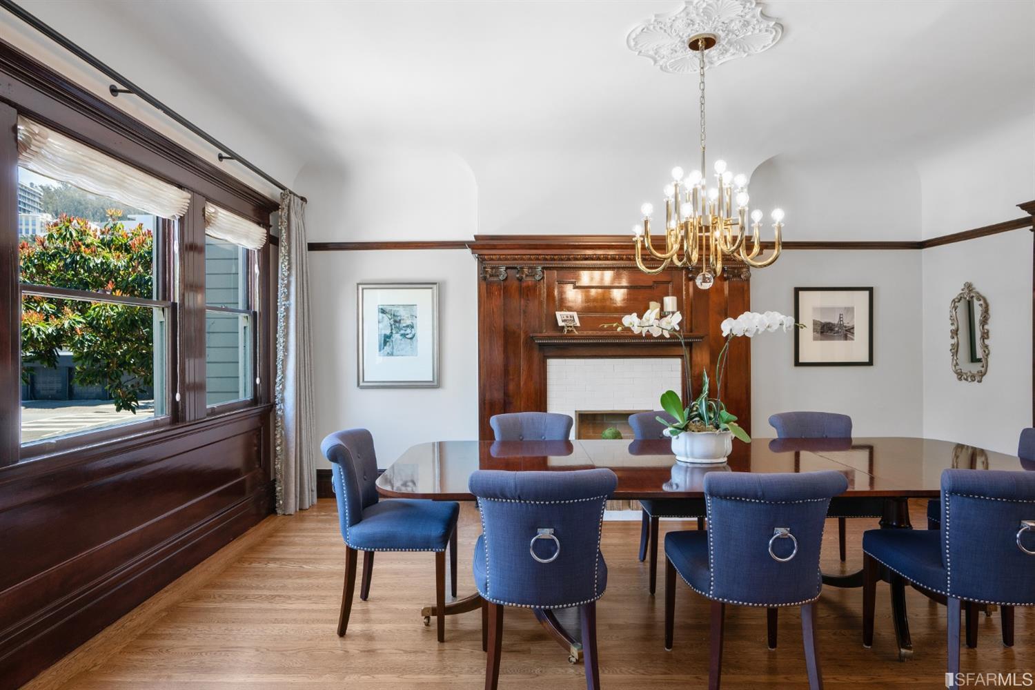 Dining View of the formal dining room, featuring an elegant chandelier and large windows