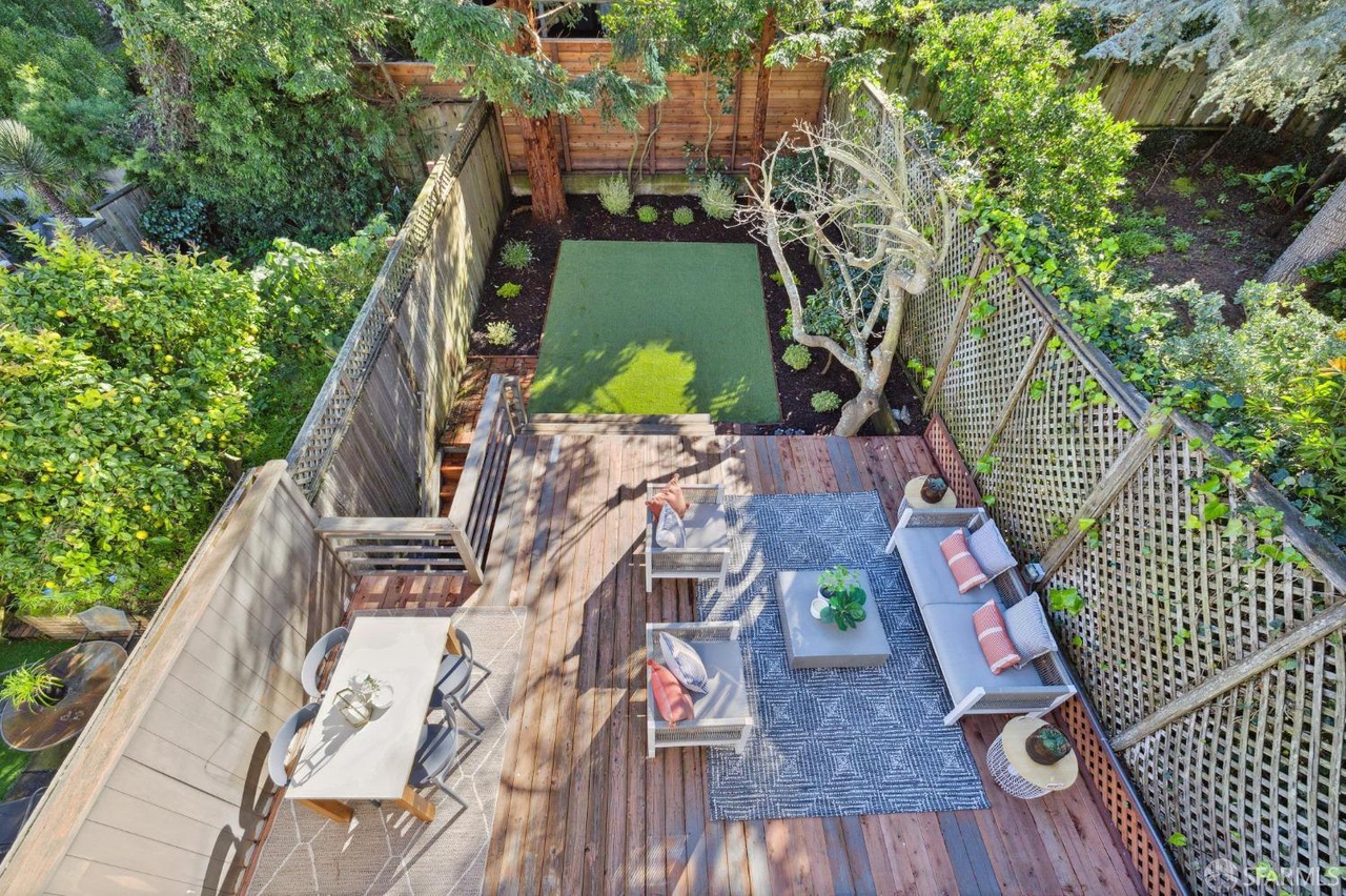 Looking down onto lower deck/yard area from upper patio.