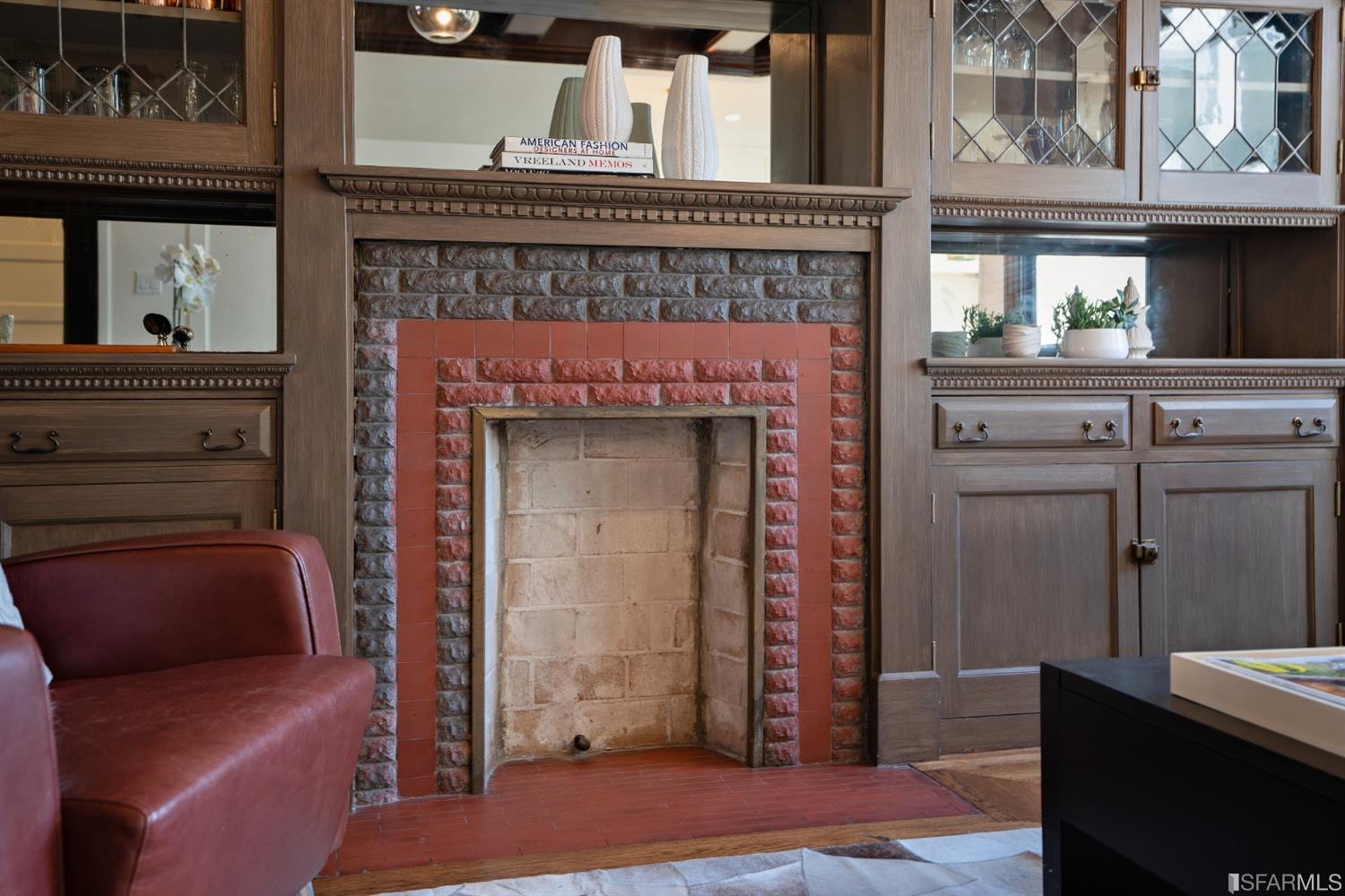 Fireplace-LV Close-up of the fireplace, showing brick surround and built-in cabinetry