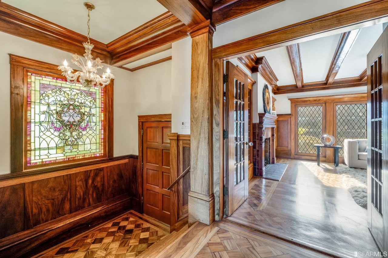 Foyer Hallway with wood floors, wood beamed ceilings and stained glass windows