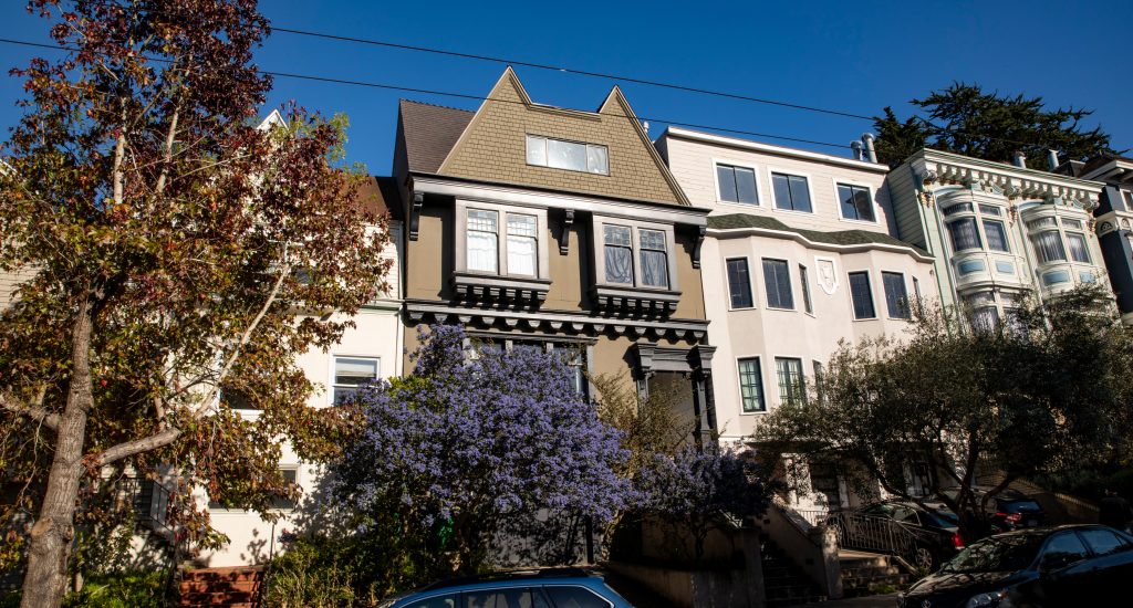 Front exterior view of 828 Ashbury, showing a home with brown facade