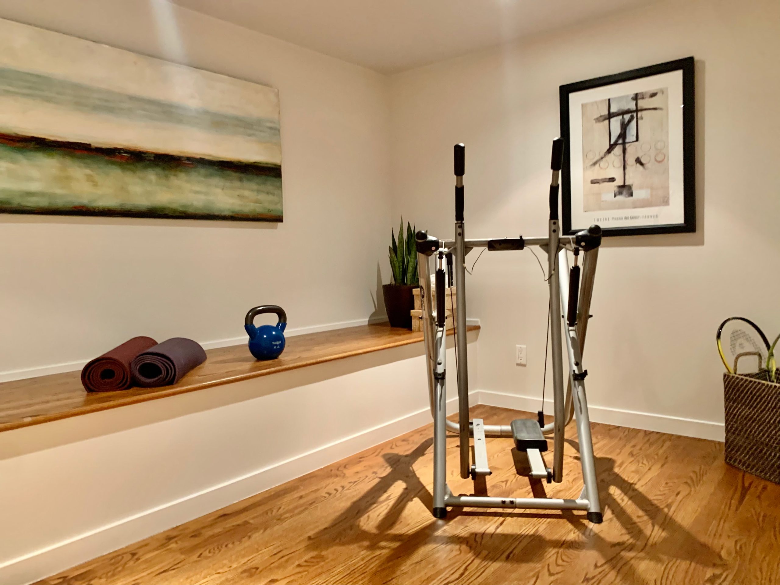 IMG8070 View of a home gym with wood floor and a built-in bench