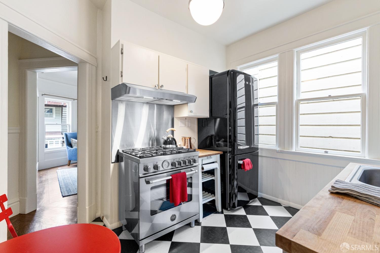 Kitchen is upper unit has stainless gass stove and hood.