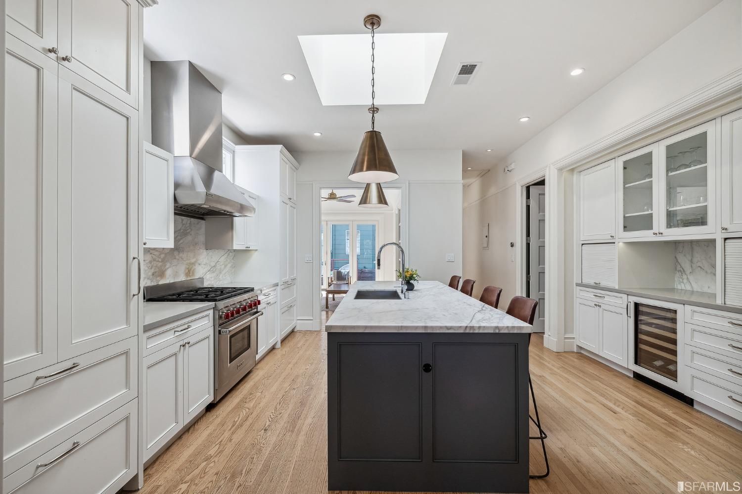 View of the kitchen at 286 Fair Oaks St, showing a large skylight, modern lighting and wood floors