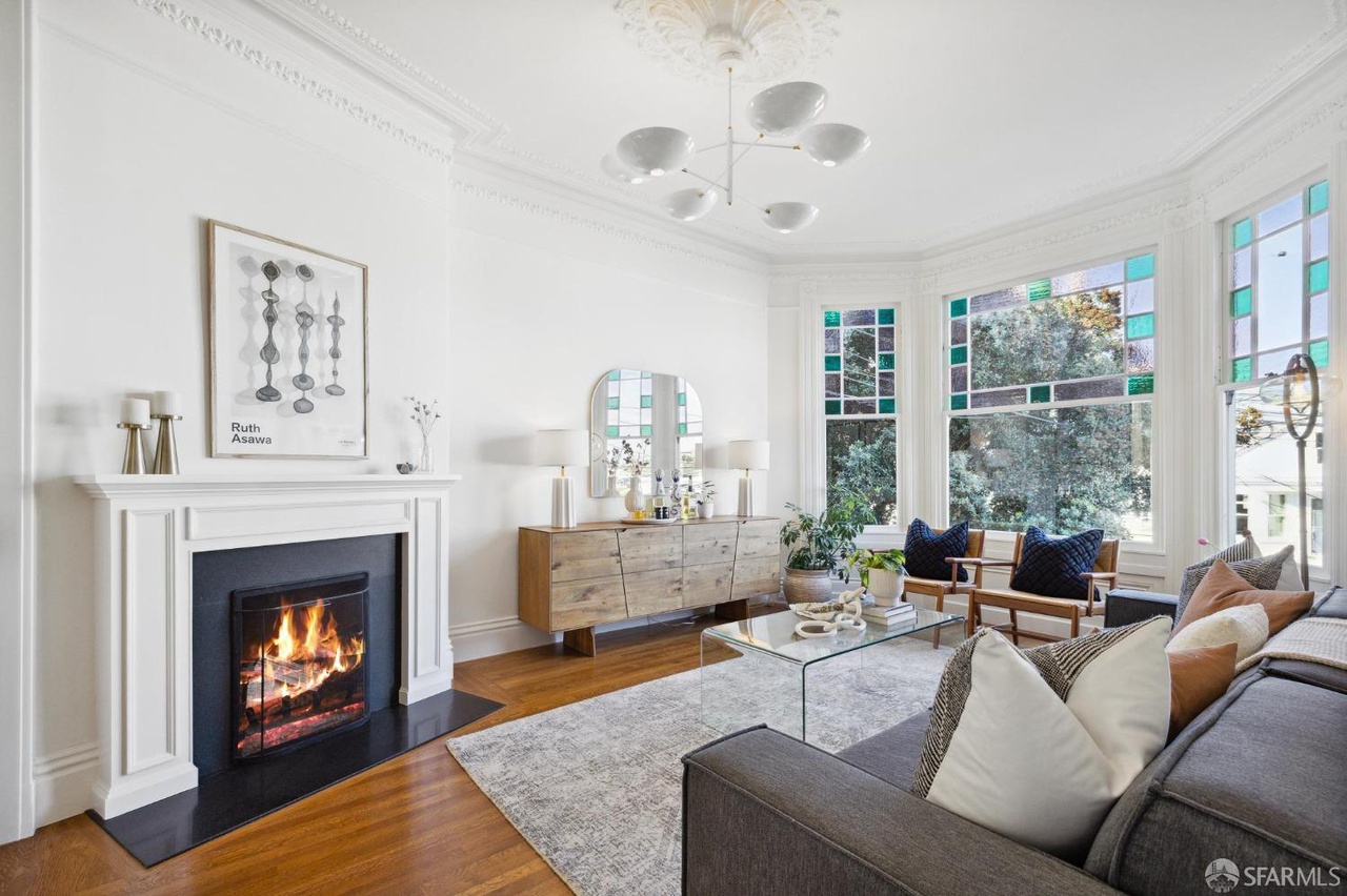 Living room has fireplace and hardwood throughout.  There is stained glass detail on upper front bay window.