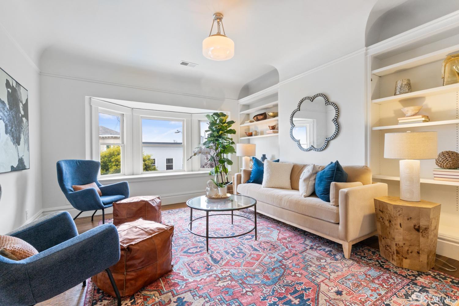 Living room in upper unit has beautiful built-ins.
