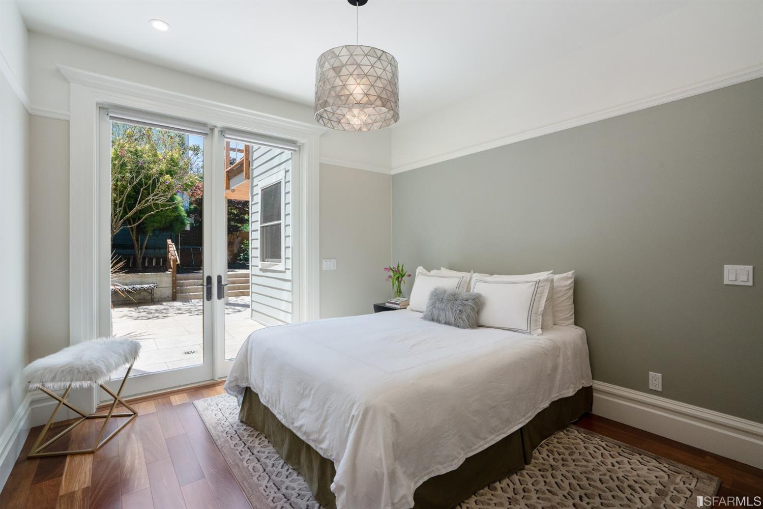 Lower-bedroom Lower bedroom with doors leading to the private yard