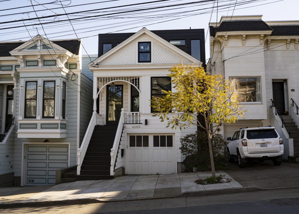Front exterior view of 4069 25th Street, showing a home with white facade
