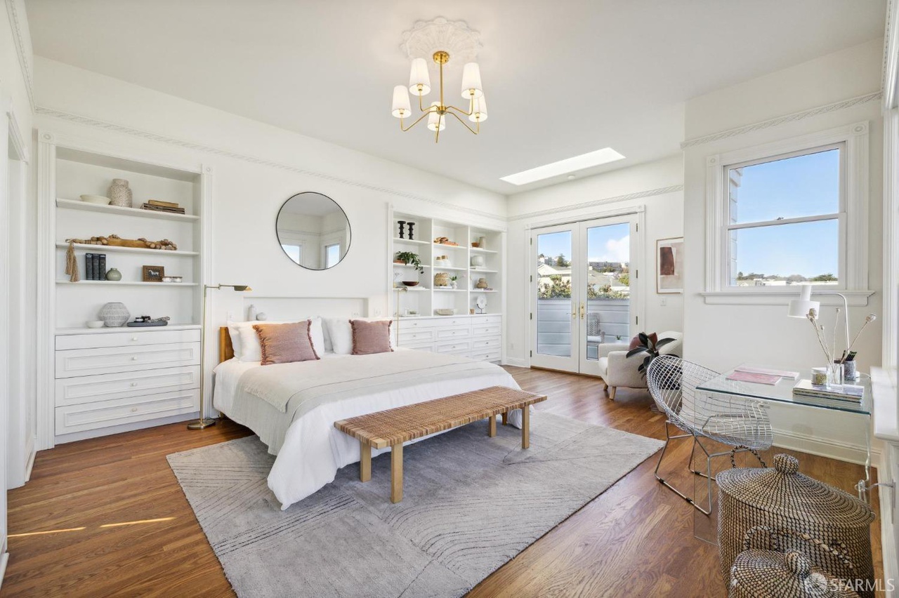 Primary bedroom has large built in on each side of bed.  There are french doors that open to deck.
