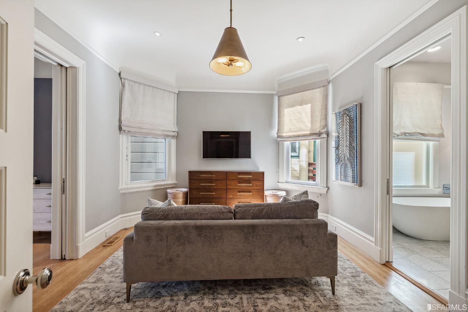 Primary bedroom sitting area, showing the door to the left leading to the bedroom and the door to the right leading to the ensuite bathroom