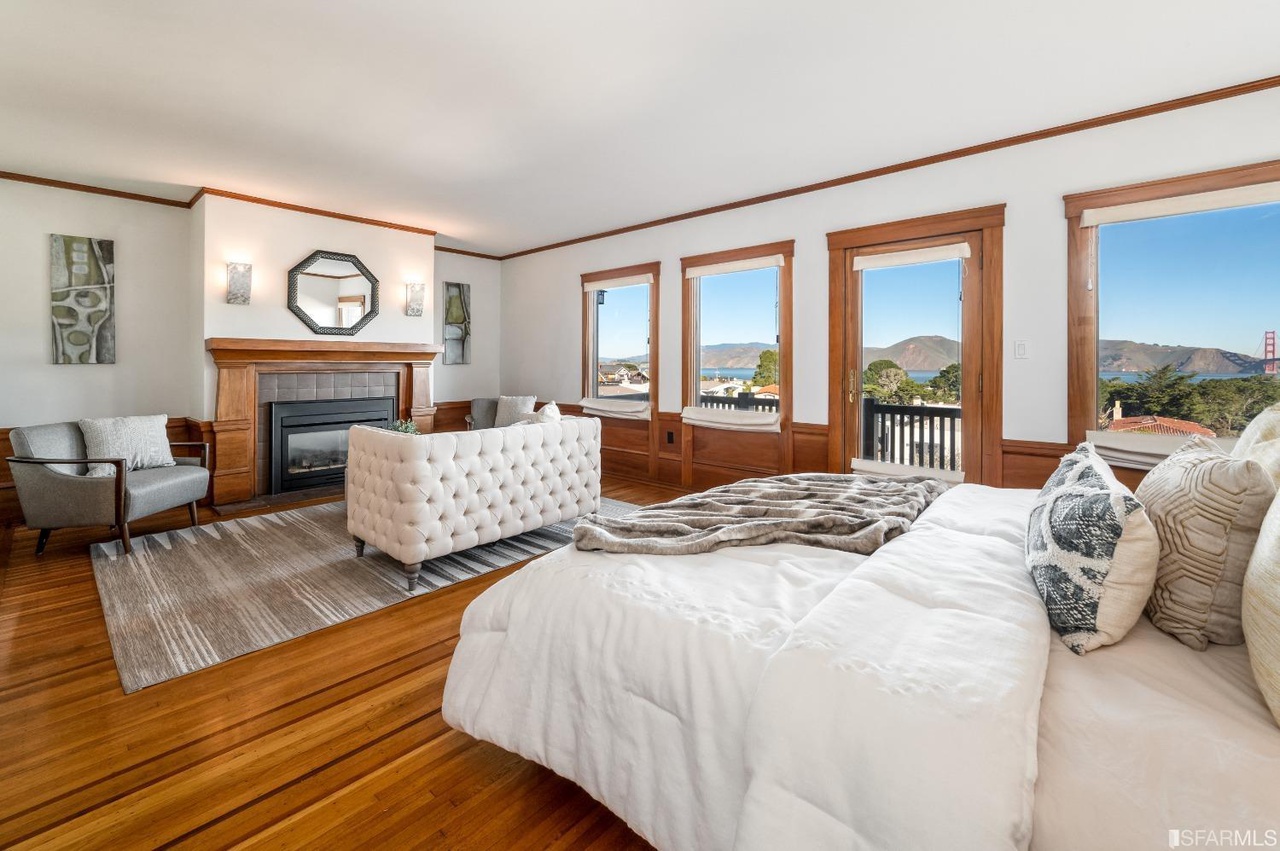 Primary View of the primary suite with a fireplace and private setting area