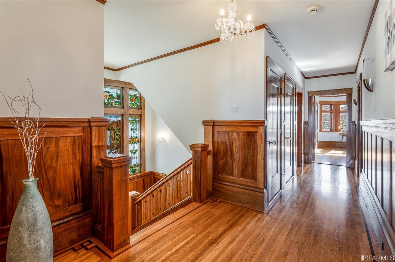 Upper-hall Hallway with wood floors and staircase leading down