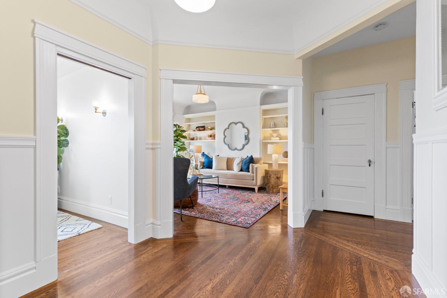 Upper unit entry.  Living room in straight ahead.  Hardwood floors throughout.