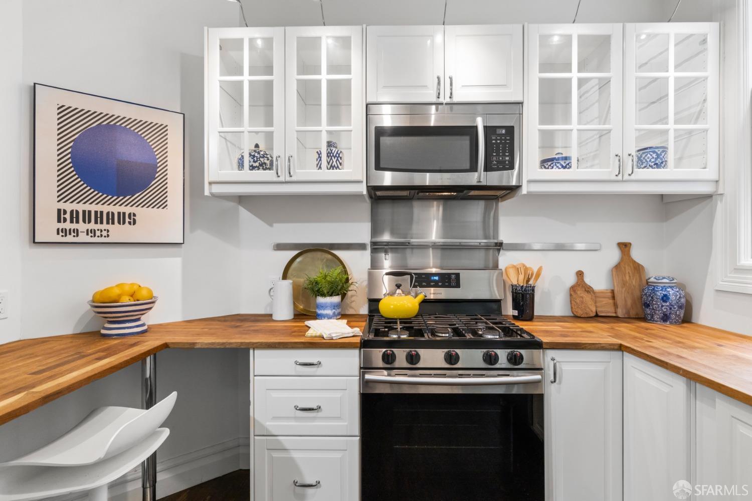 Showing the stainless stove and microwave in kitchen.