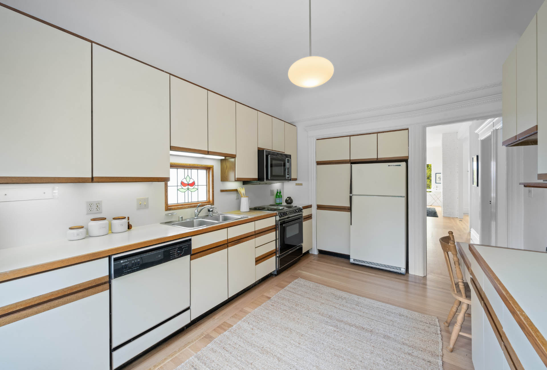 kitchen-buena-vista-ave-east Kitchen has hardwood floors throughout with lots of upper and lower cabinates.