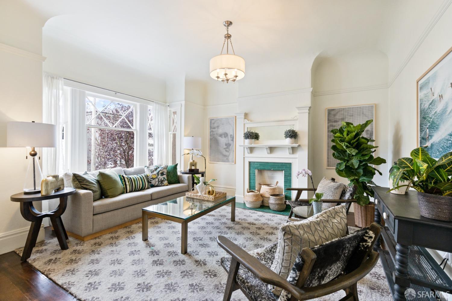 Living room has beautiful molding detail and has large windows that look out over Woodland Street.