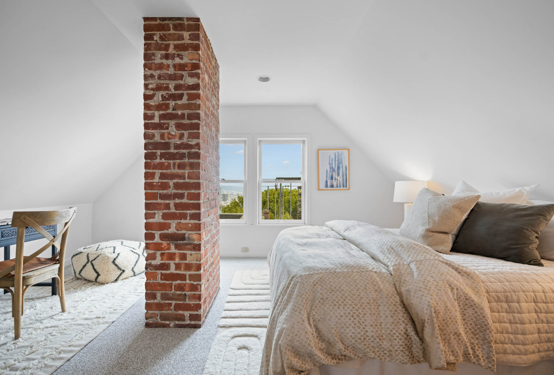 loft-room-living-area-of171-173-Buena-vista-ave-east There is a brick chimney that goes through the large upper level space.